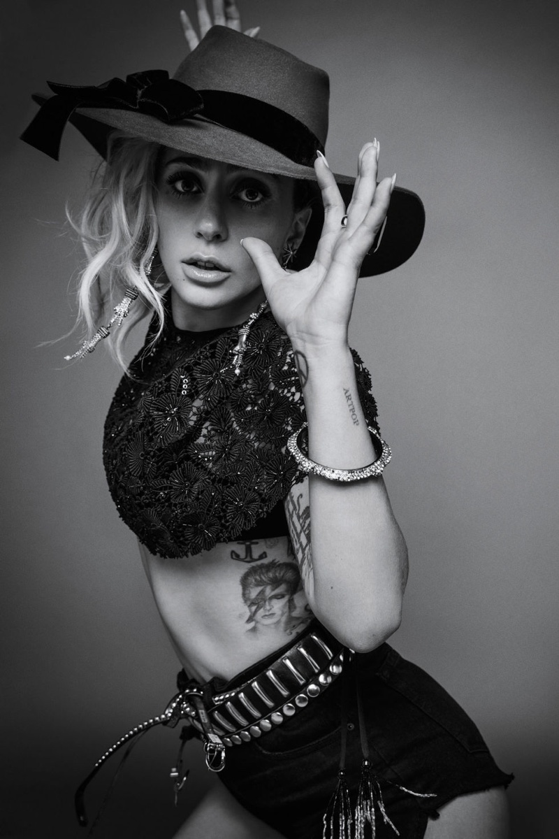 Lady Gaga poses in Valentino cape, La Perla bra, Denim x Alexander Wang shorts and Preston & Olivia hat