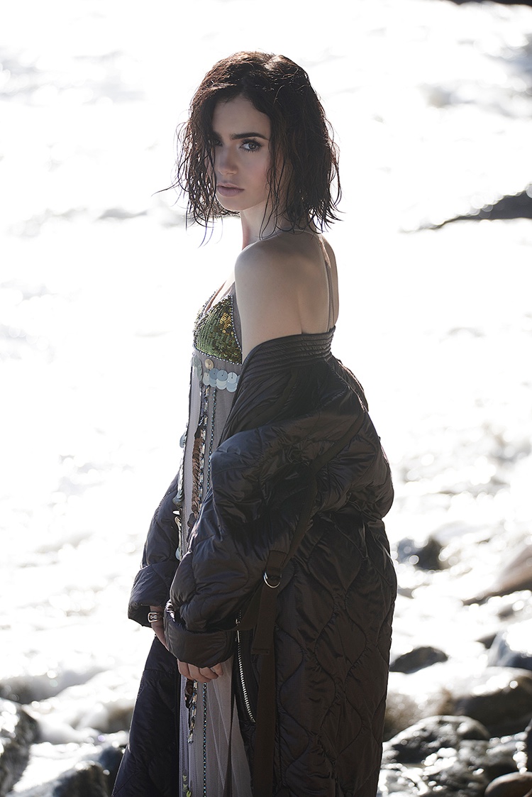 Posing on the beach, Lily Collins wears puffer jacket with embellished slip dress Vera Wang