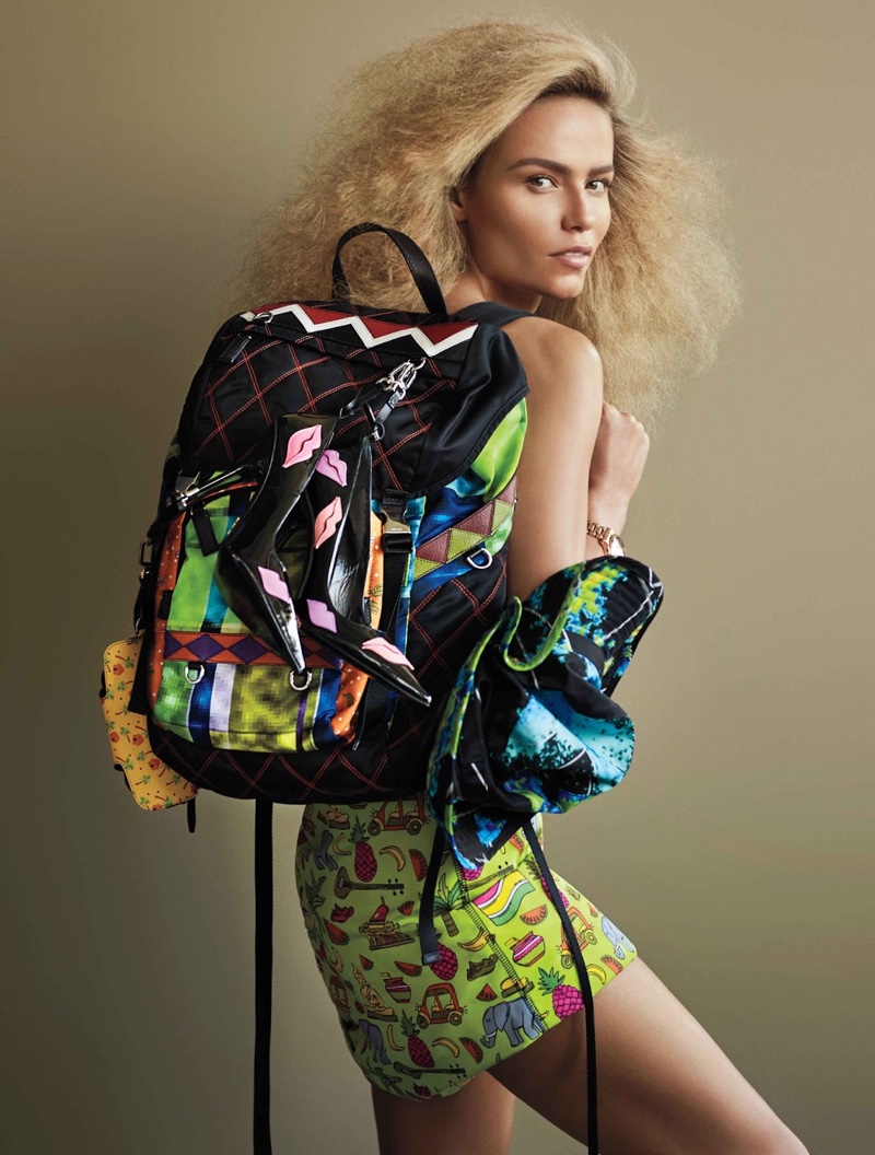 Natasha Poly covers up in Prada bags and skirt