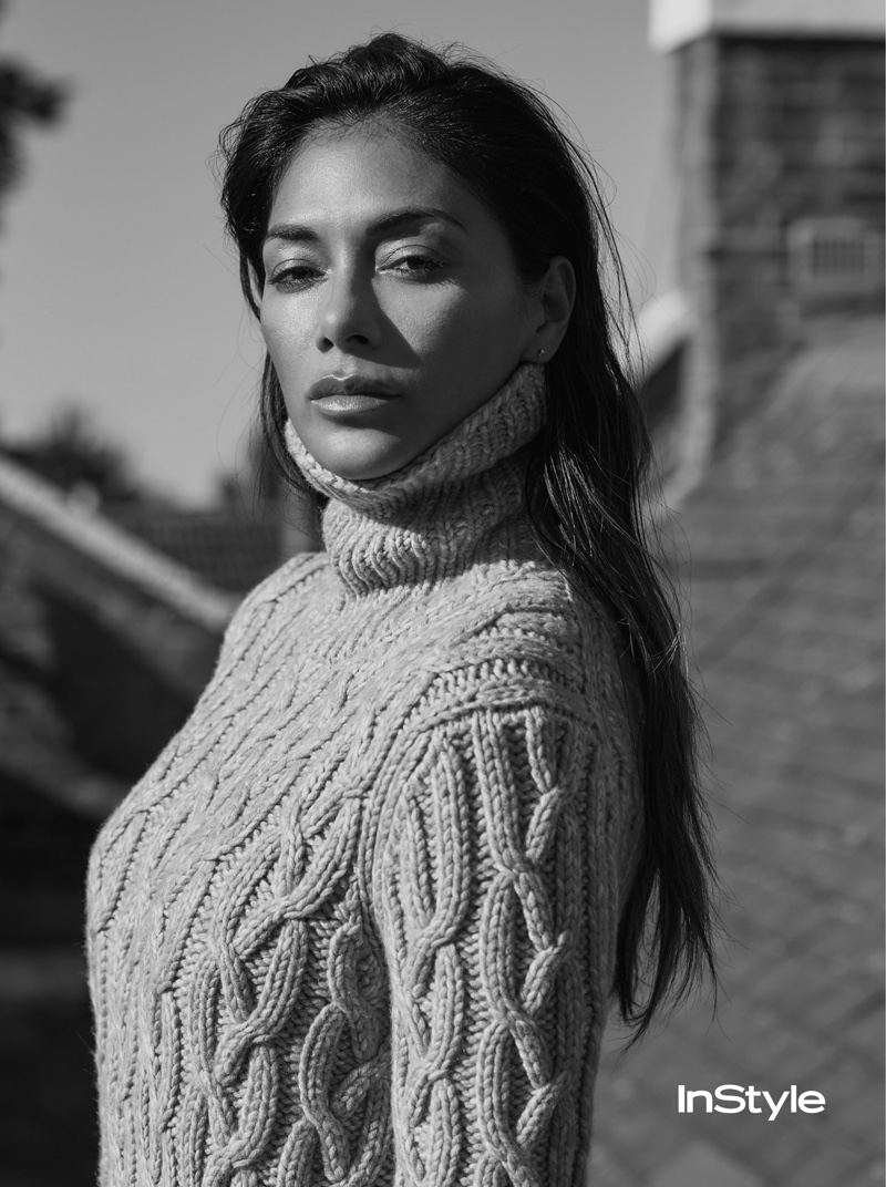 Wearing a cable-knit sweater, Nicole Scherzinger gets photographed in black and white