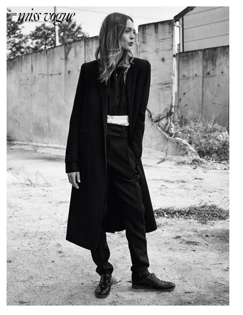 Wearing a long coat, Sasha Pivovarova layers up in this dark look featuring Marciano, Guess, Prada and Victoria Beckham