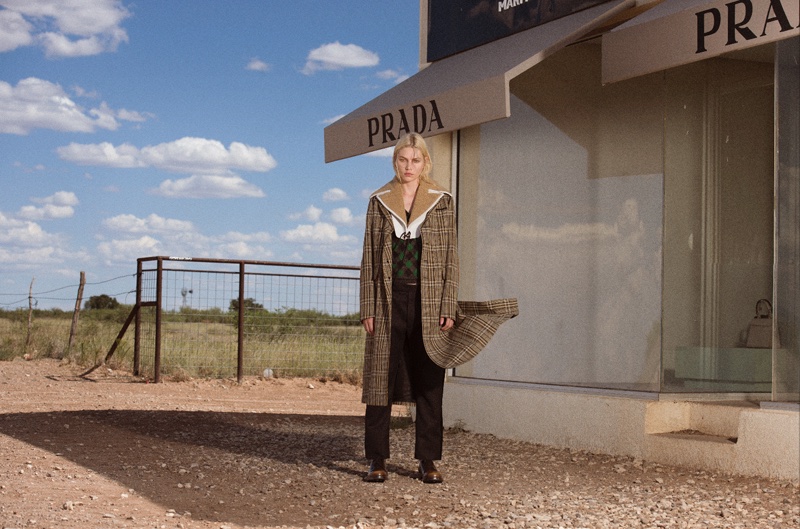 Model Aline Weber poses in a dirt road outside of the Prada Marfa installment