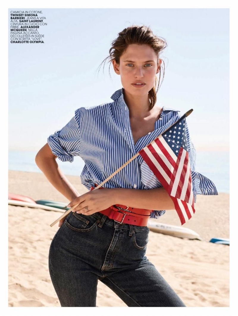 Waving an American flag, Bianca Balti models Twinset shirt, Saint Laurent jeans and Alexander McQueen belt