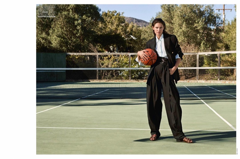 Model Bianca Balti suits up in Celine blazer, pants and top with Valentino sandals