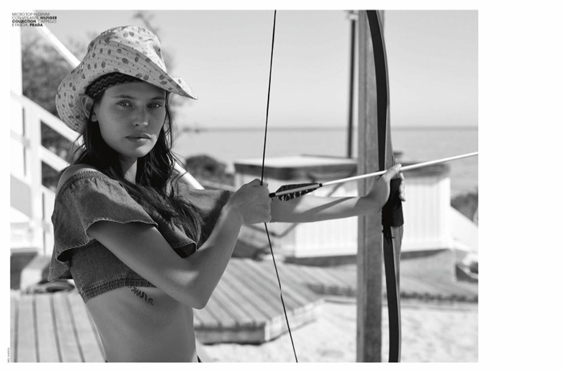 Photographed in black and white, Bianca Balti wears Hilfiger Collection cropped top and Prada hat