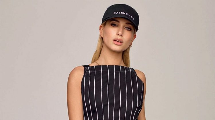 Getting sporty, Hailey Baldwin wears Balenciaga baseball cap and striped dress