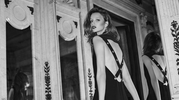 The model flaunts her back in a Versus Versace dress