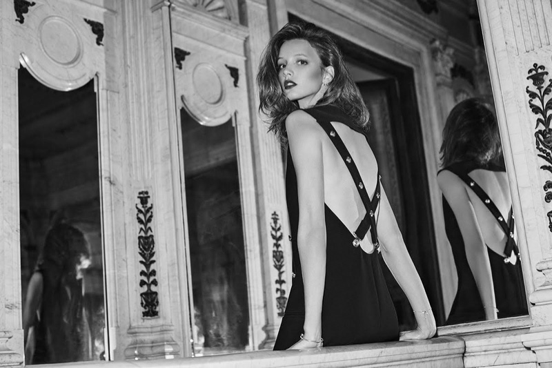 The model flaunts her back in a Versus Versace dress