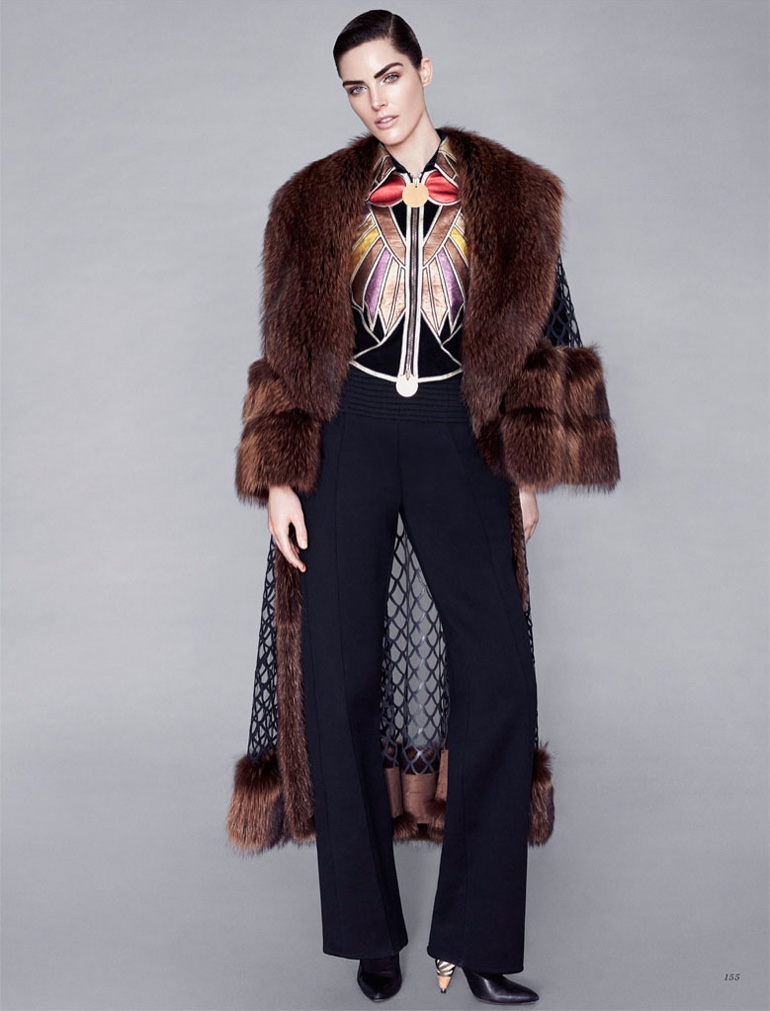 Embracing fur, the model poses in Givenchy fur coat, top and trousers