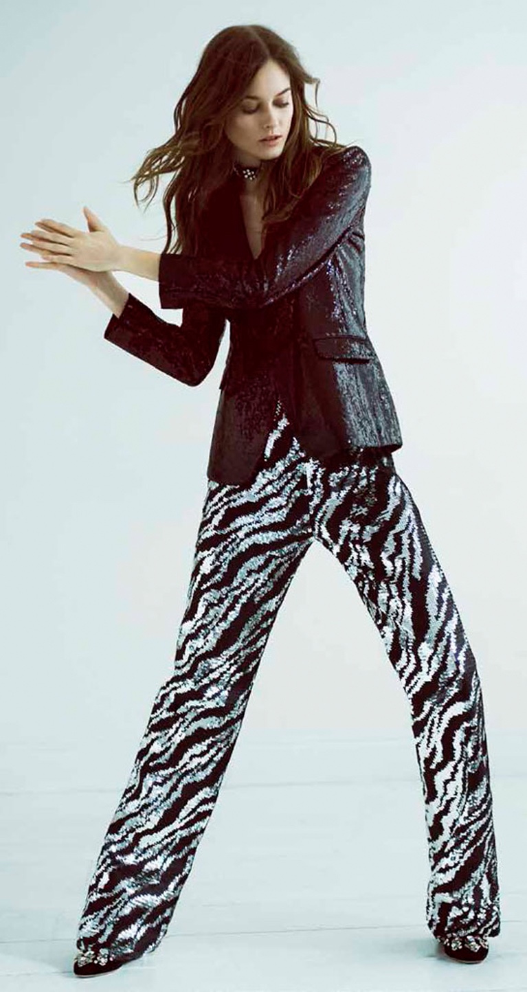 Model Jac Jagaciak poses in fitted blazer and printed pants