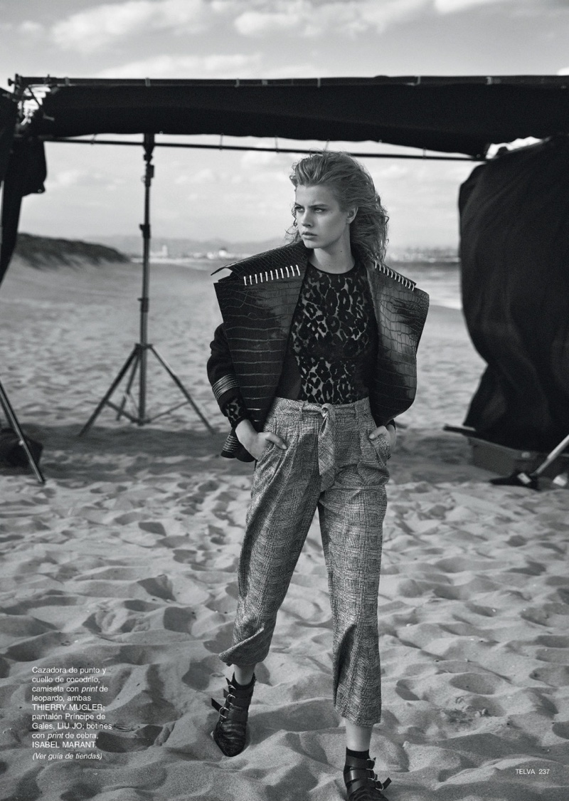Posing on the beach, the model wears a Mugler jacket and top with Liu Jo pants