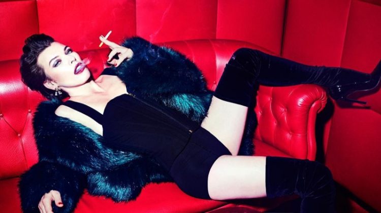 Milla Jovovich wears Dries Van Noten fur jacket with Cadolle lingerie and Balenciaga pumps