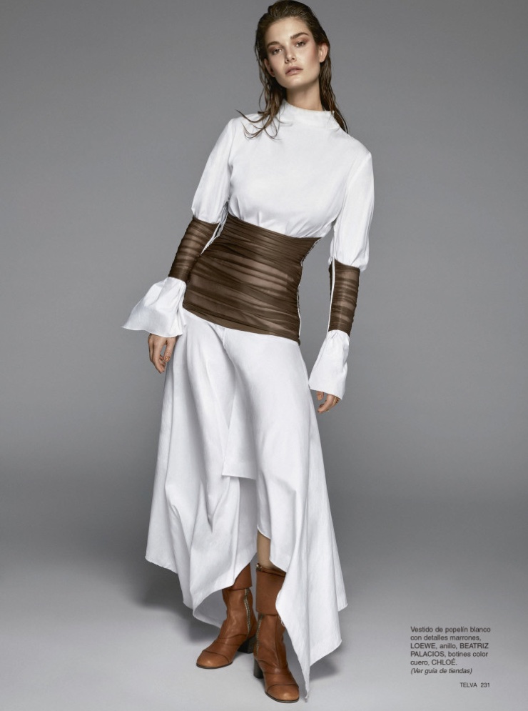 Model Ophelie Guillermand poses in Loewe poplin dress with Chloe boots
