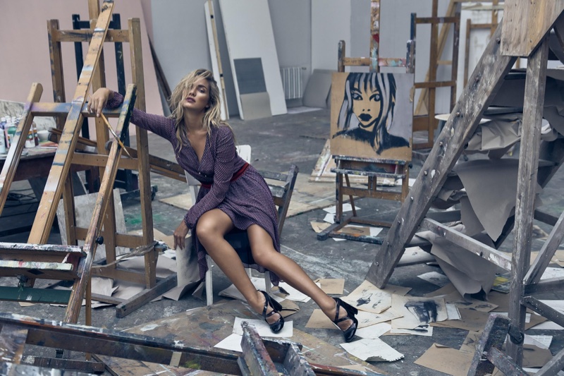 Surrounded by easels, Tatana Kucharova poses in a Tory Burch wrap dress