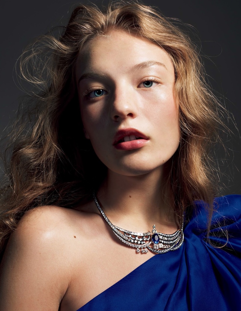 The model poses in dazzling jewelry looks for the editorial