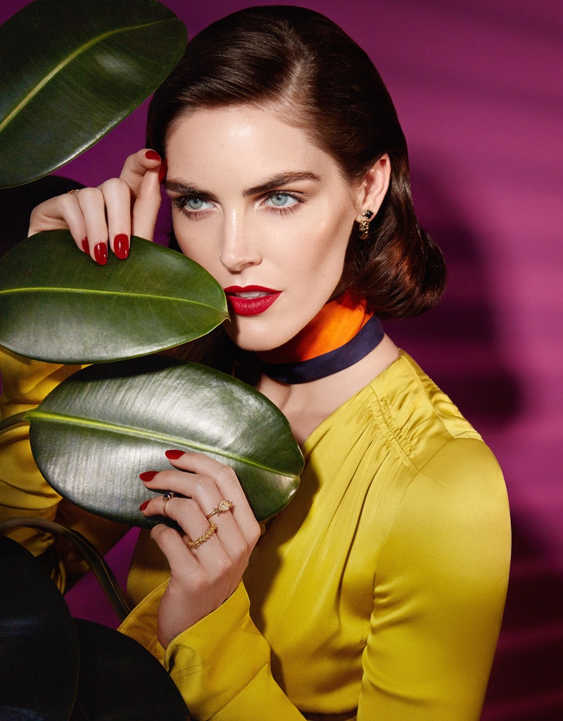 Hilary Rhoda poses with dark-red lipstick and matching manicure