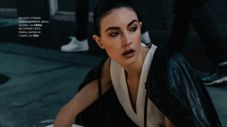 Sitting on the sidewalk, Jacquelyn Jablonski models Celine dress, pants, jacket and sandals