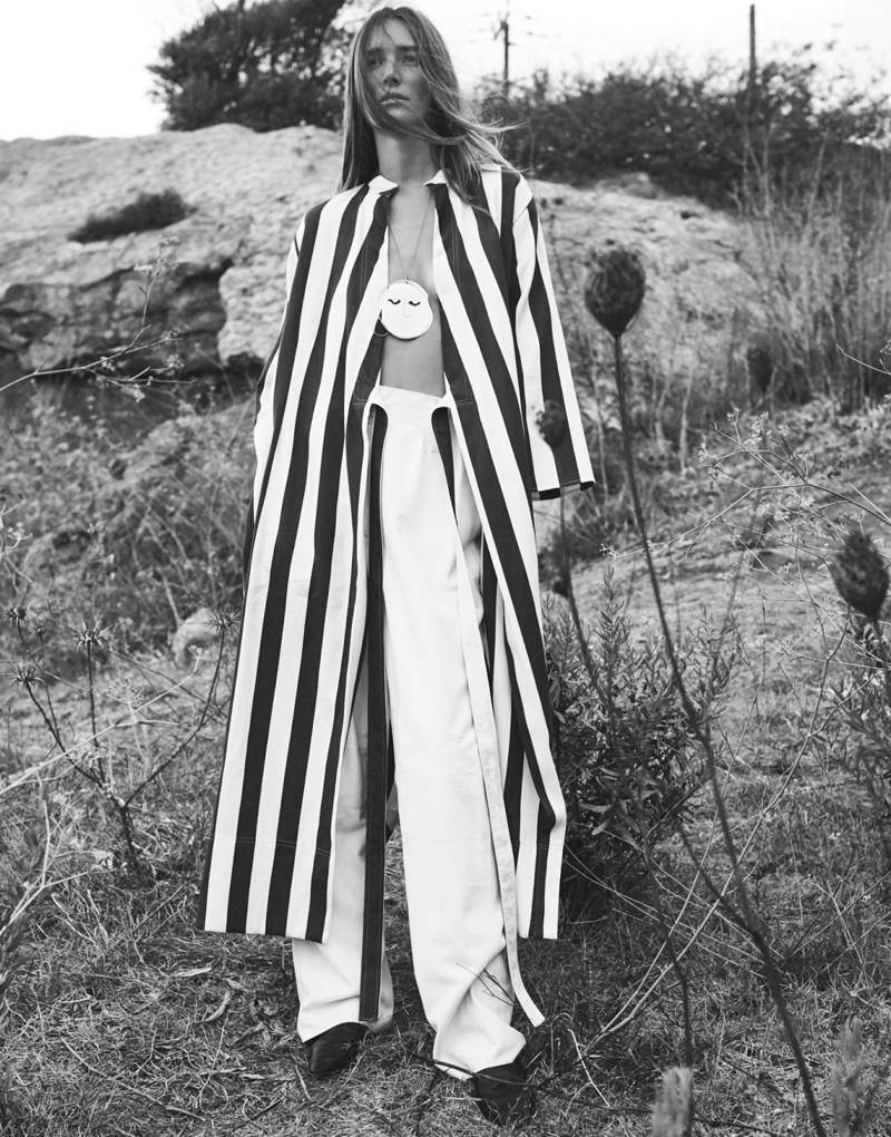 Photographed in black and white, the model wears Joseph robe, Tibi pants, Vince shoes and J.W. Anderson necklace