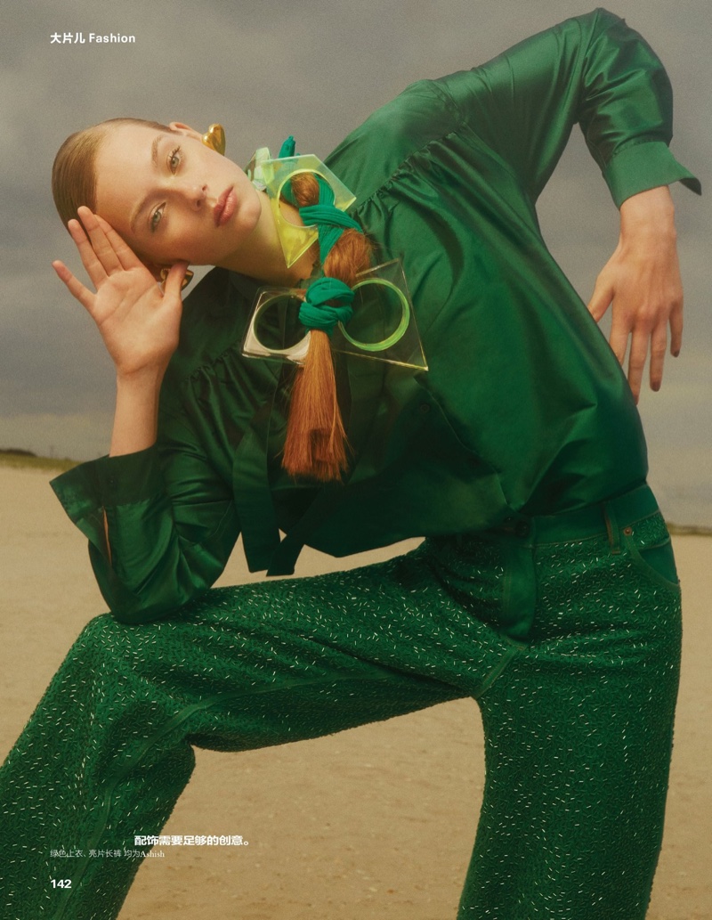 Wearing green, Lauren de Graaf models Ashish top and trousers