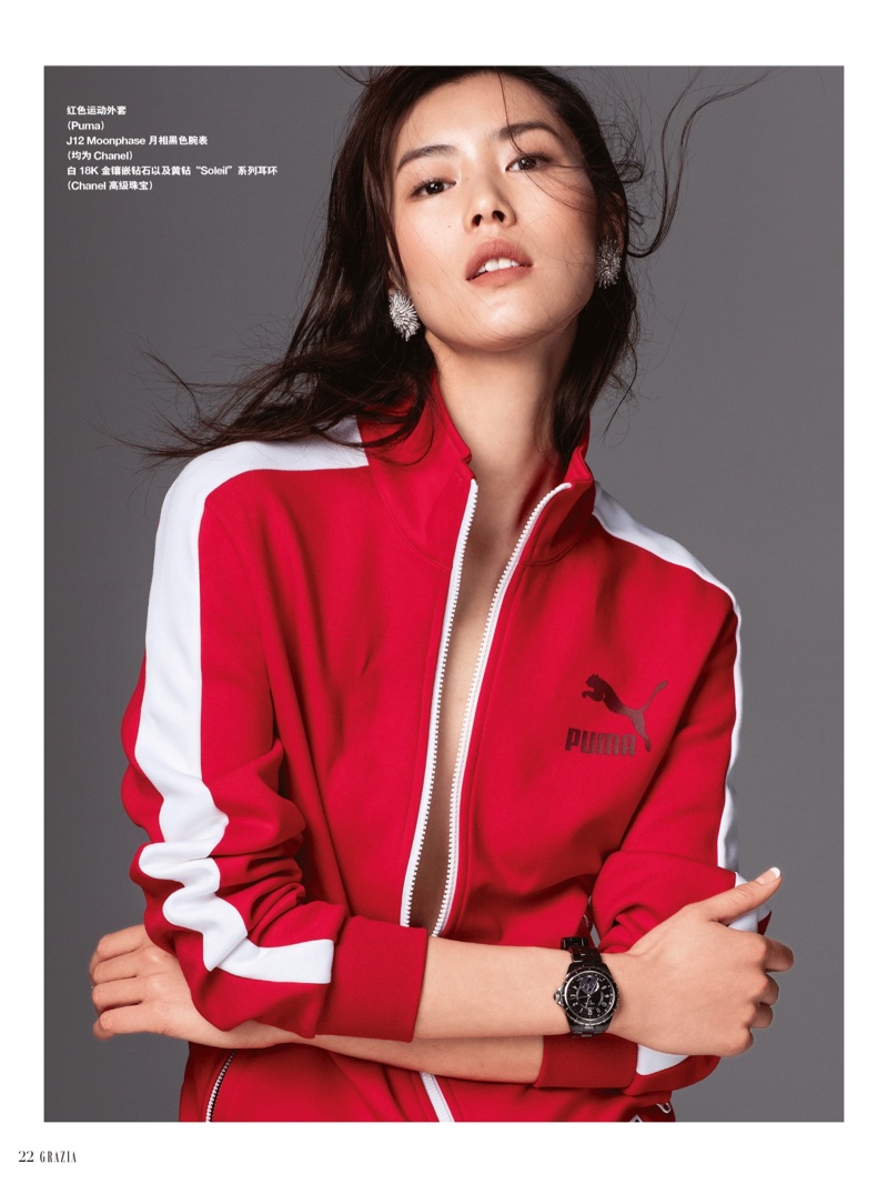 Model Liu Wen poses in Puma track jacket with Chanel earrings and watch