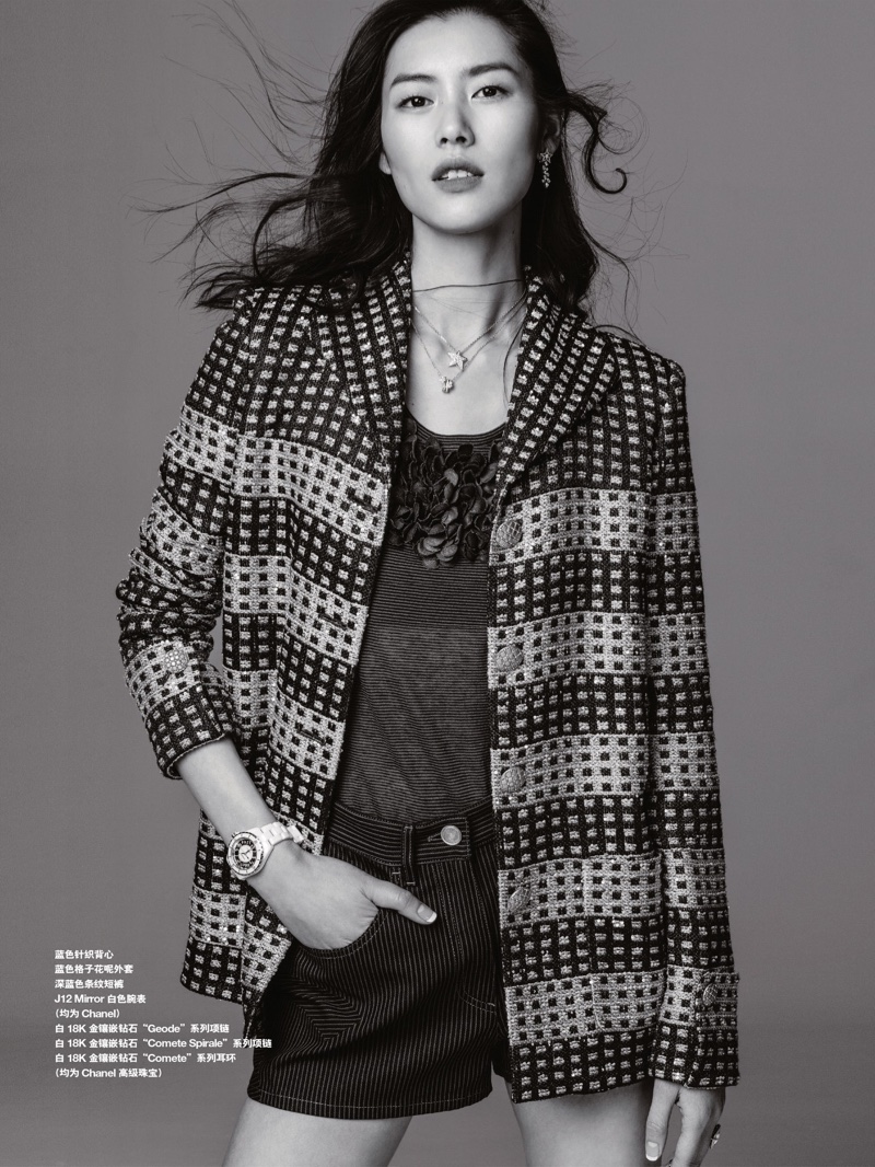 Photographed in black and white, Liu Wen poses in Chanel jacket, top, shorts and jewelry