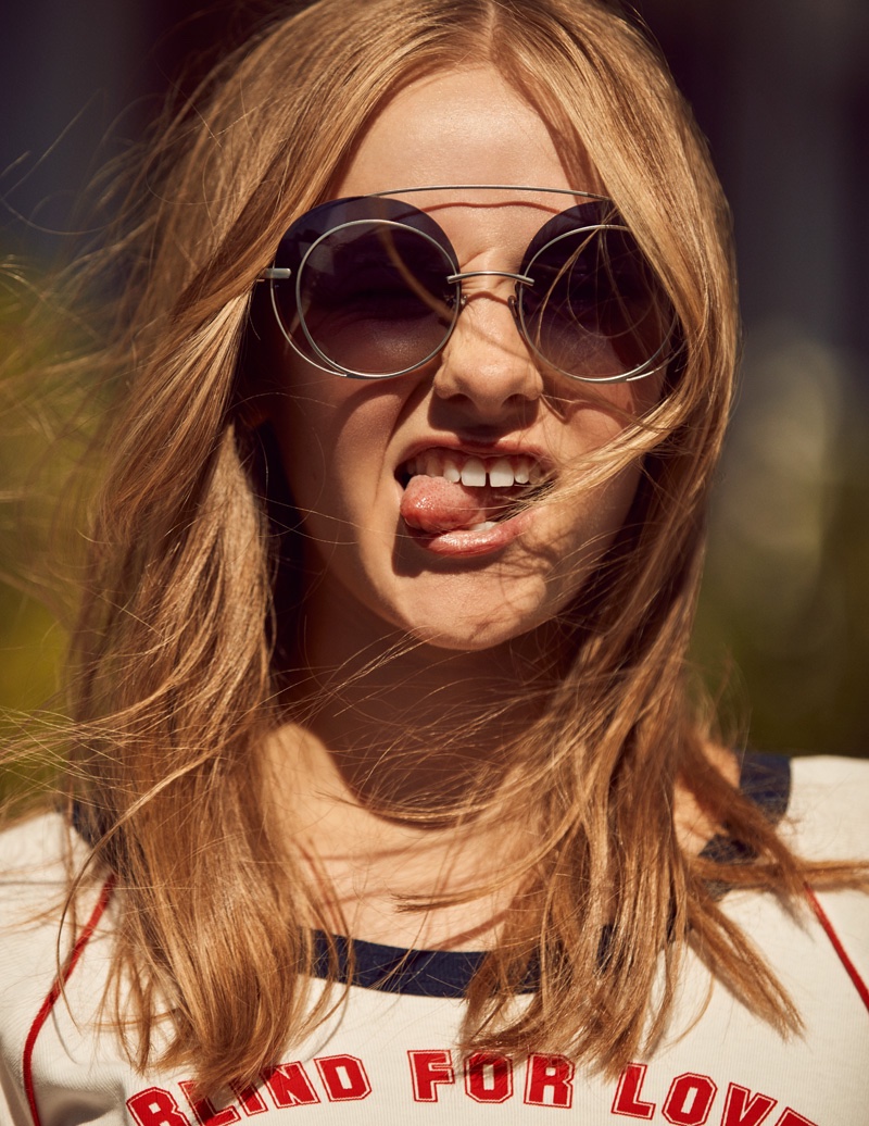 Sticking out her tongue, Maddi Waterhouse sports Giorgio Armani sunglasses