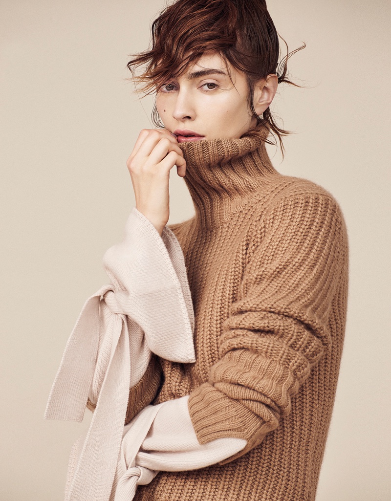 Model Marine Deleeuw poses in Michael Kors Collection sweater with Tibi top