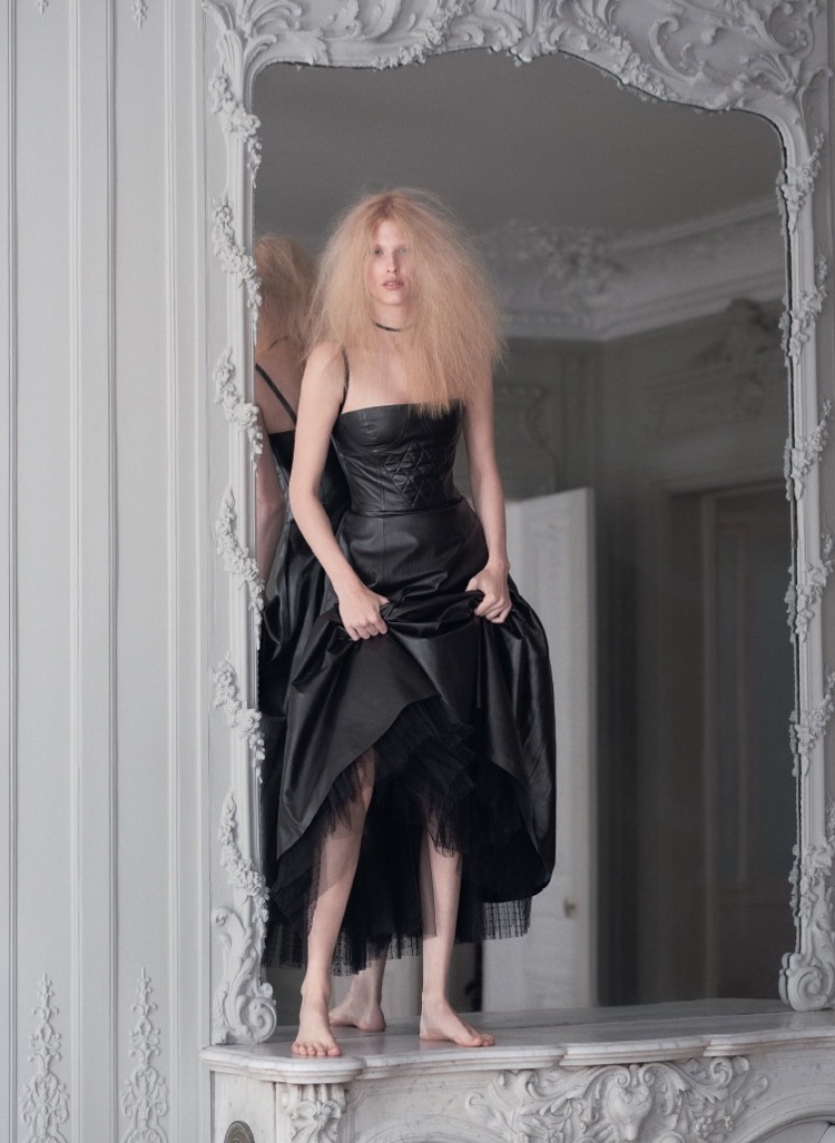 Model Niki Trefilova poses in Dior leather dress with quilted detail