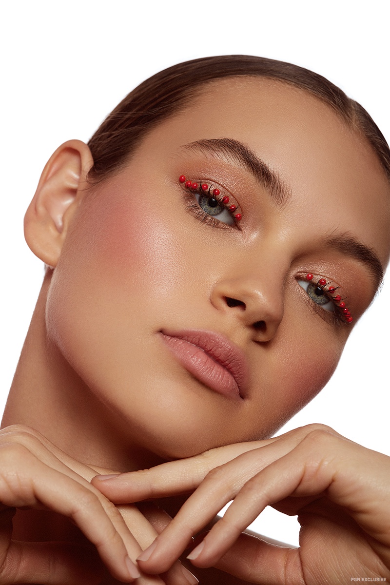 The model wears eye makeup decorated with red spheres. Photo: Beth Sternbaum
