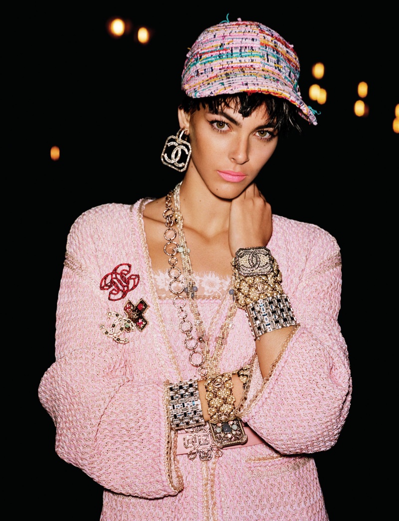 Vittoria Ceretti looks pretty in pink wearing Chanel cap, cardigan, top, dress and jewelry