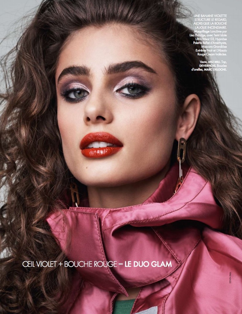 With her hair in waves, Taylor Hill shines with red lipstick and glittery eyeshadow