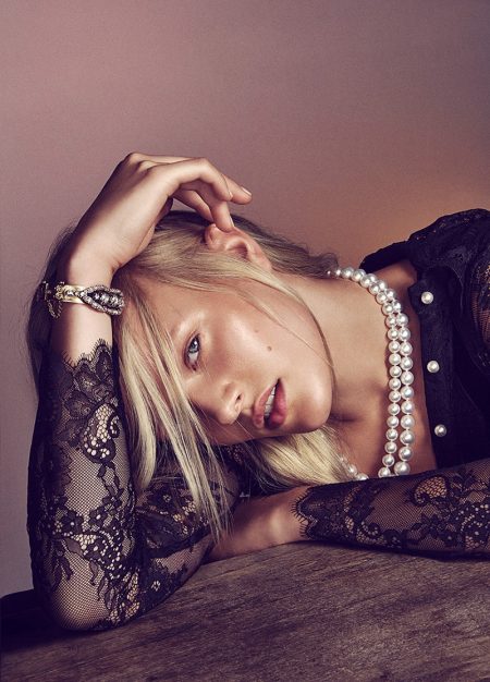 Vivien Wysocki wears lace top with pearl necklace and sparkling cuff
