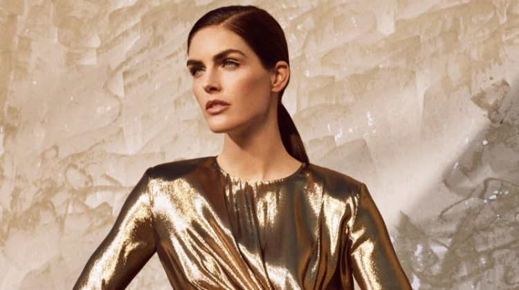 Shining in gold, Hilary Rhoda models Saint Laurent metallic dress