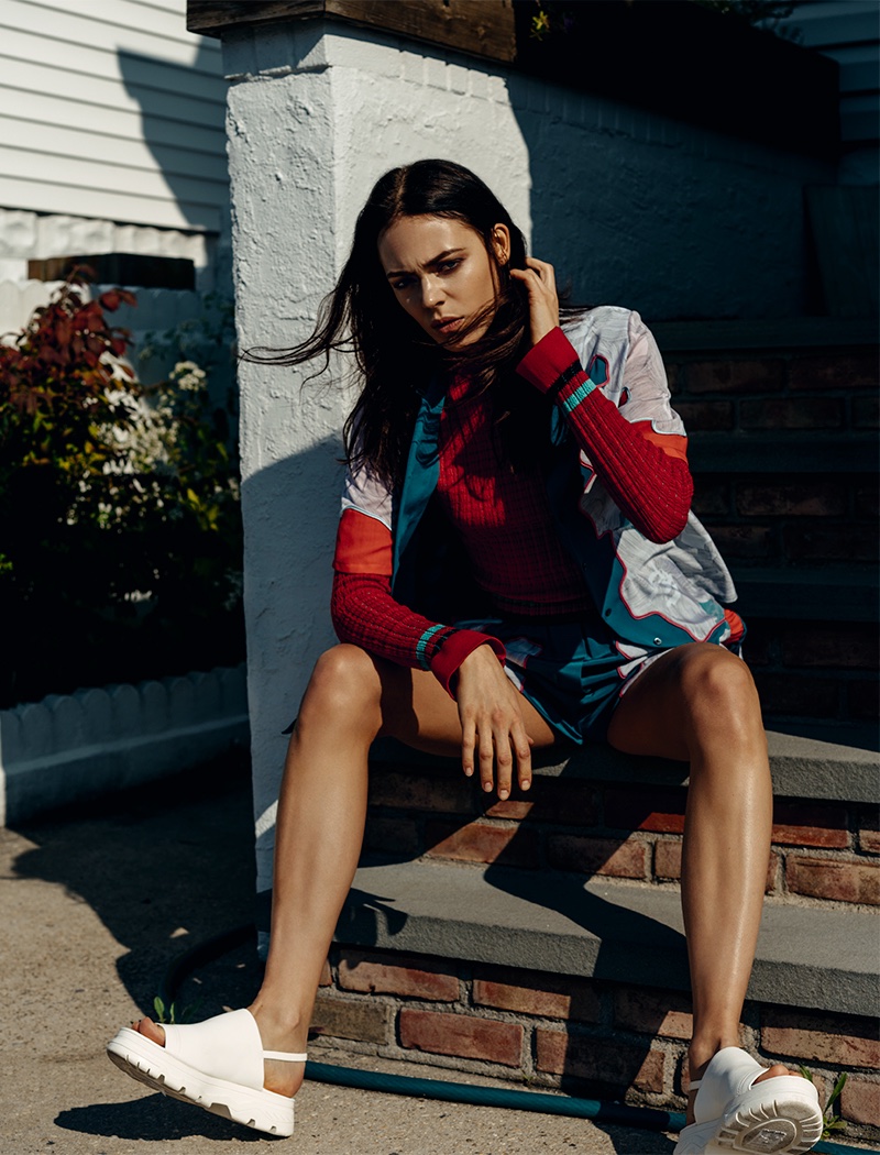 Taking a seat, Kinga Rajzak poses in 3.1 Phillip Lim shirt, top and shorts with DKNY slippers