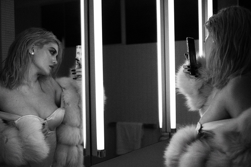 Taking a selfie, Kylie Jenner poses in fur coat with corset bodysuit