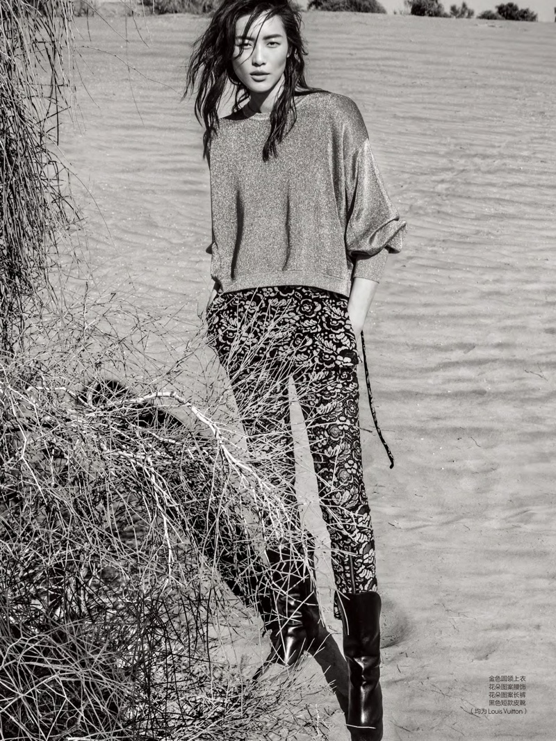 Photographed in black and white, Liu Wen wears Louis Vuitton top, printed pants and boots