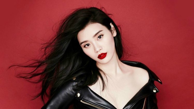 Putting on a pair of boxing gloves, Ming Xi poses in Moschino leather jacket dress
