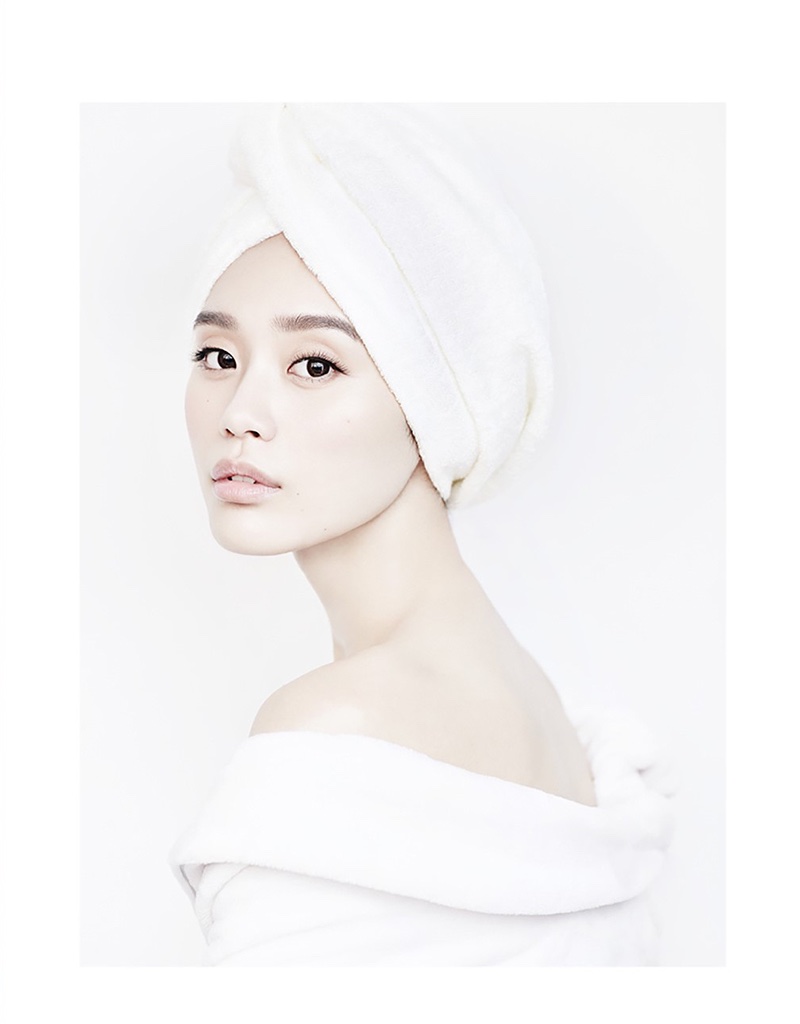 Covering up in a robe, Ming Xi wears a towel on her head