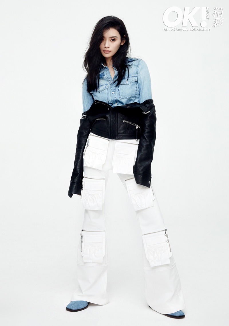 Model Ming Xi wears denim shirt, leather jacket and zippered pants