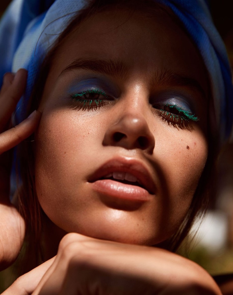 Showing off blue eyeshadow, Olivia Aarnio models Jac and Jack beach towel on her head