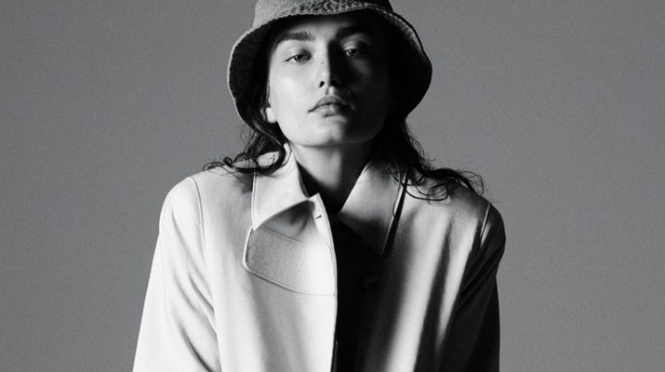 Model Andreea Diaconu poses in Prada trench coat with House of Lafayette hat