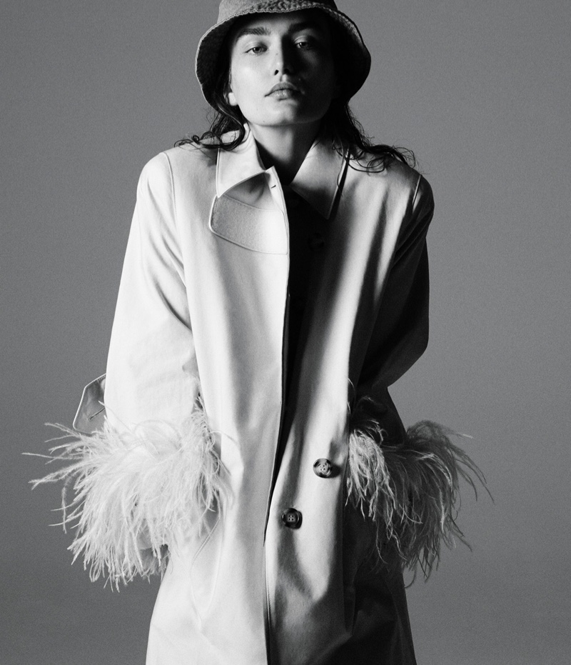 Model Andreea Diaconu poses in Prada trench coat with House of Lafayette hat