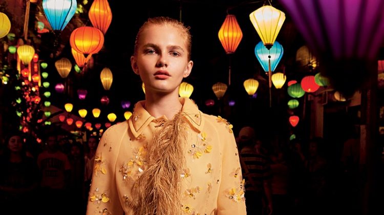 Posing in a street full of lanterns, the model wears Prada embellished coat and belt