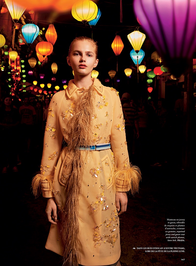 Posing in a street full of lanterns, the model wears Prada embellished coat and belt