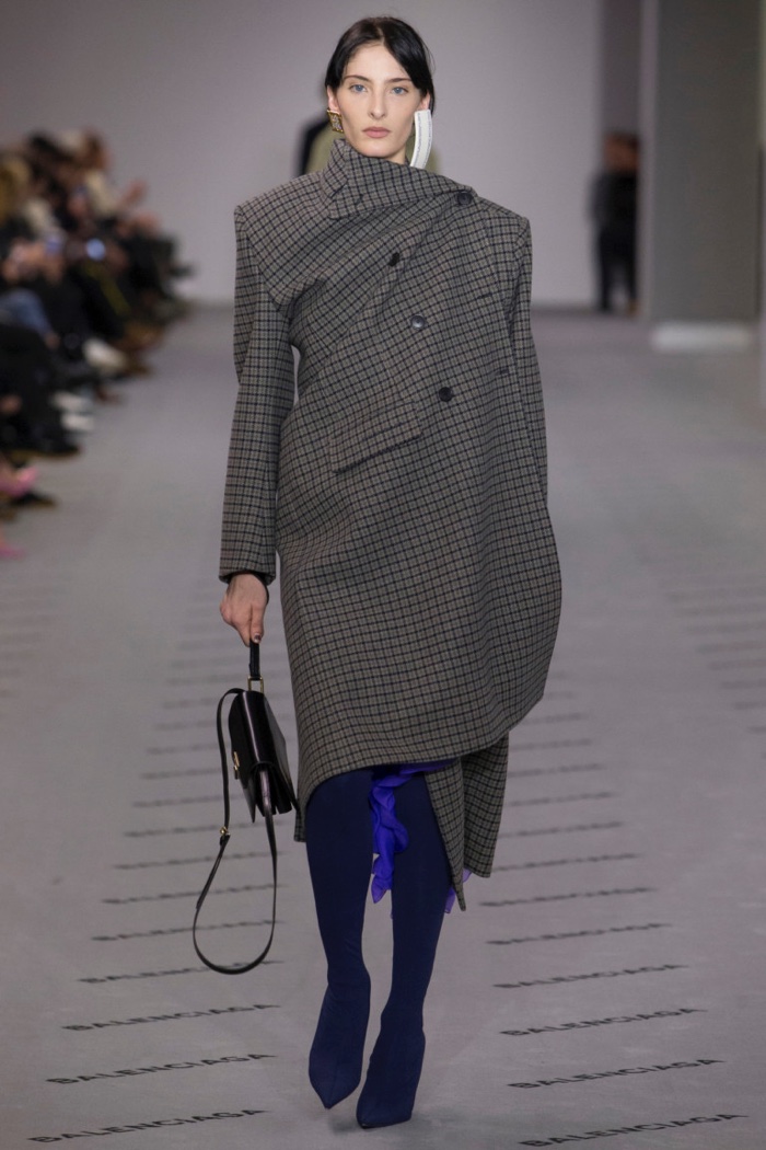 Checkered print draped coat over pointed toe boots from Balenciaga’s fall-winter 2017 collection