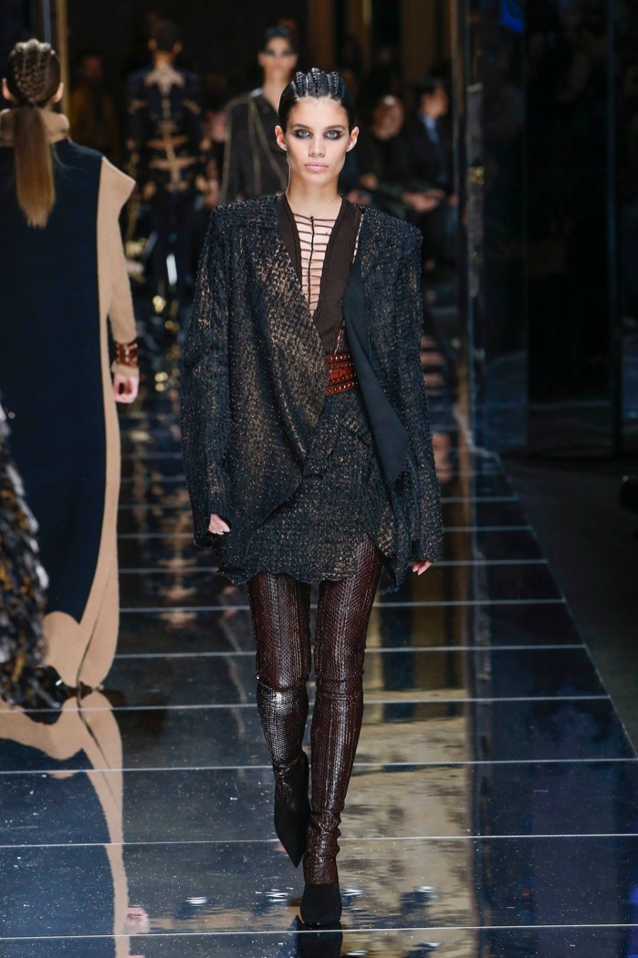 Sara Sampaio wears metallic embroidered draped coat with asymmetrical skirt from Balmain’s fall-winter 2017 collection