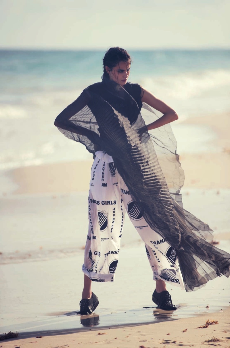 Posing on the beach, Blanca Padilla wears Stella McCartney top and pants with Yohji Yamamoto sneakers