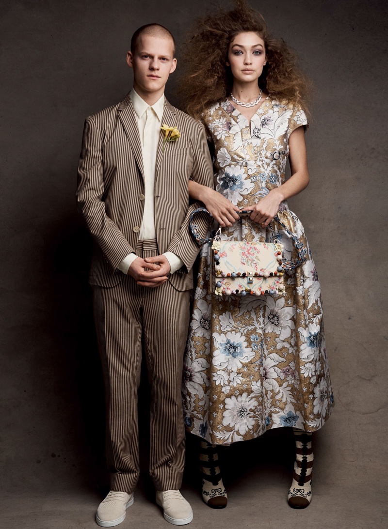 Posing with Lucas Hedges, Gigi Hadid models Fendi brocade dress, bag and boots