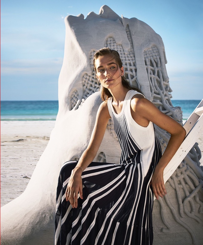 Posing next to a sand castle, Josephine le Tutour models Chloe dress with Tacori earrings