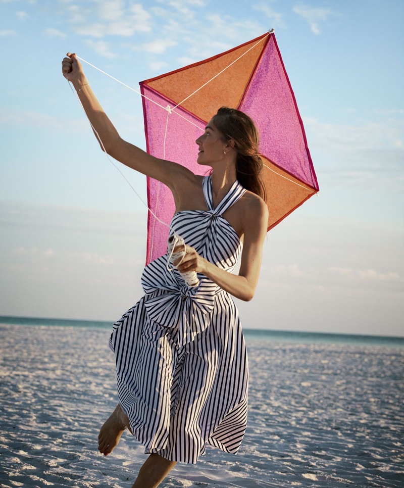 Flying a kite, Josephine le Tutour wears CH Carolina Herrera dress and Tacori earrings
